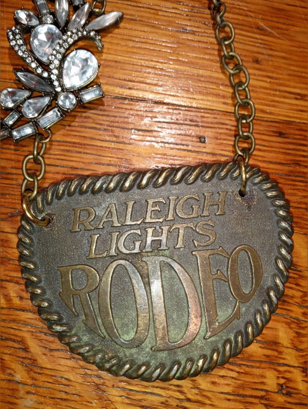 Raleigh Lights Rodeo Brass Belt Buckle Necklace - Bronze Tone